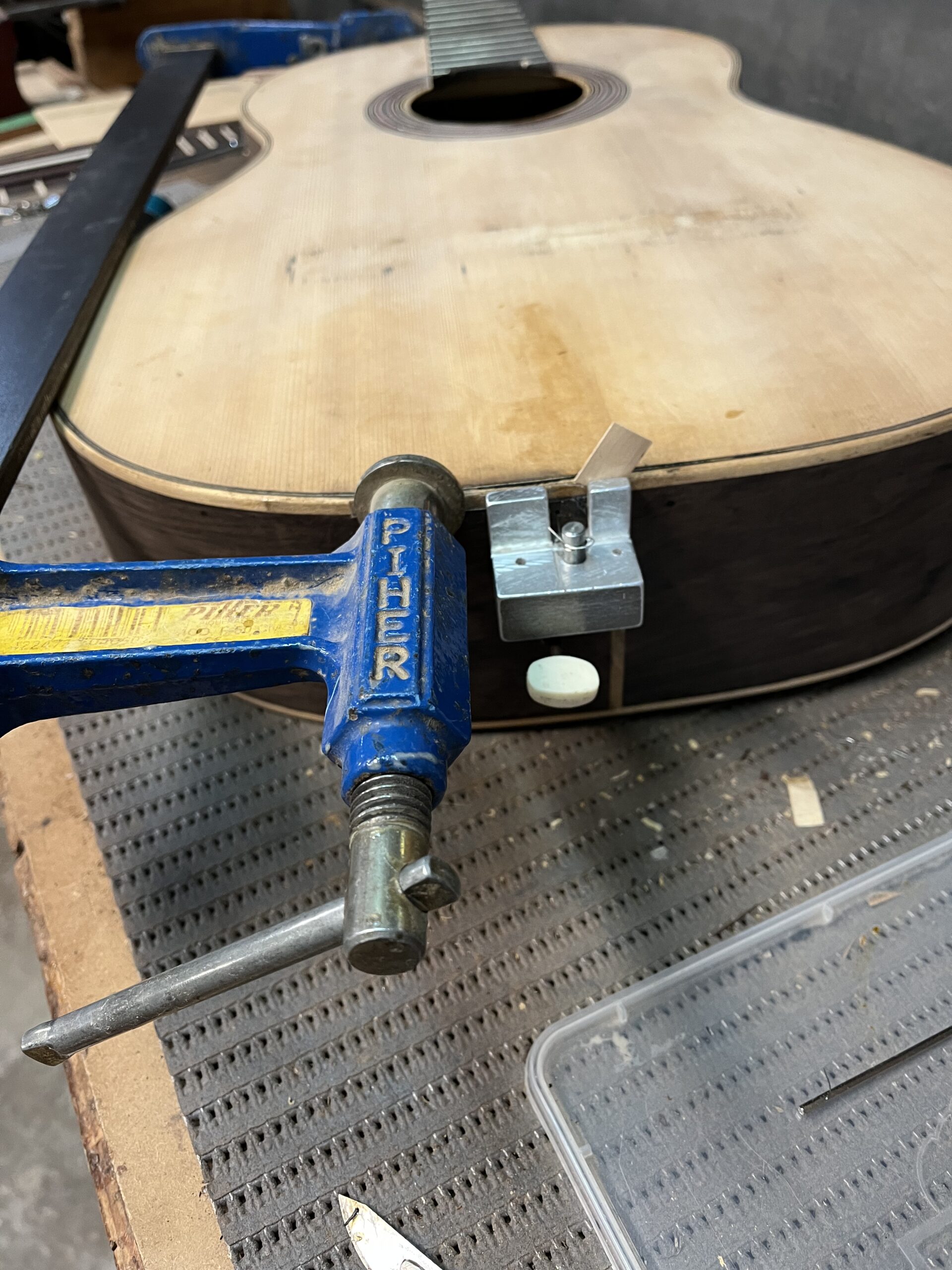 Aluminium pieces made in the workshop to apply pressure from inside the guitar