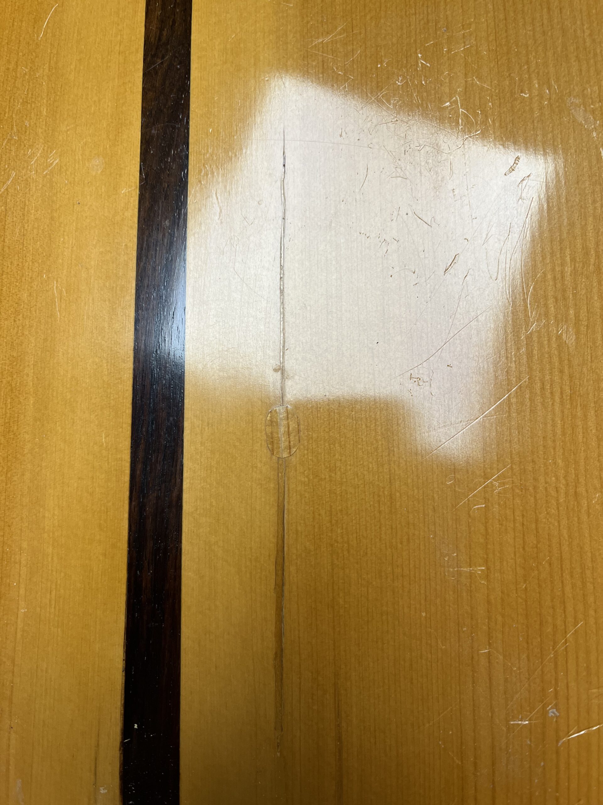 Crack in the exterior of the flamenco guitar’s cypress back