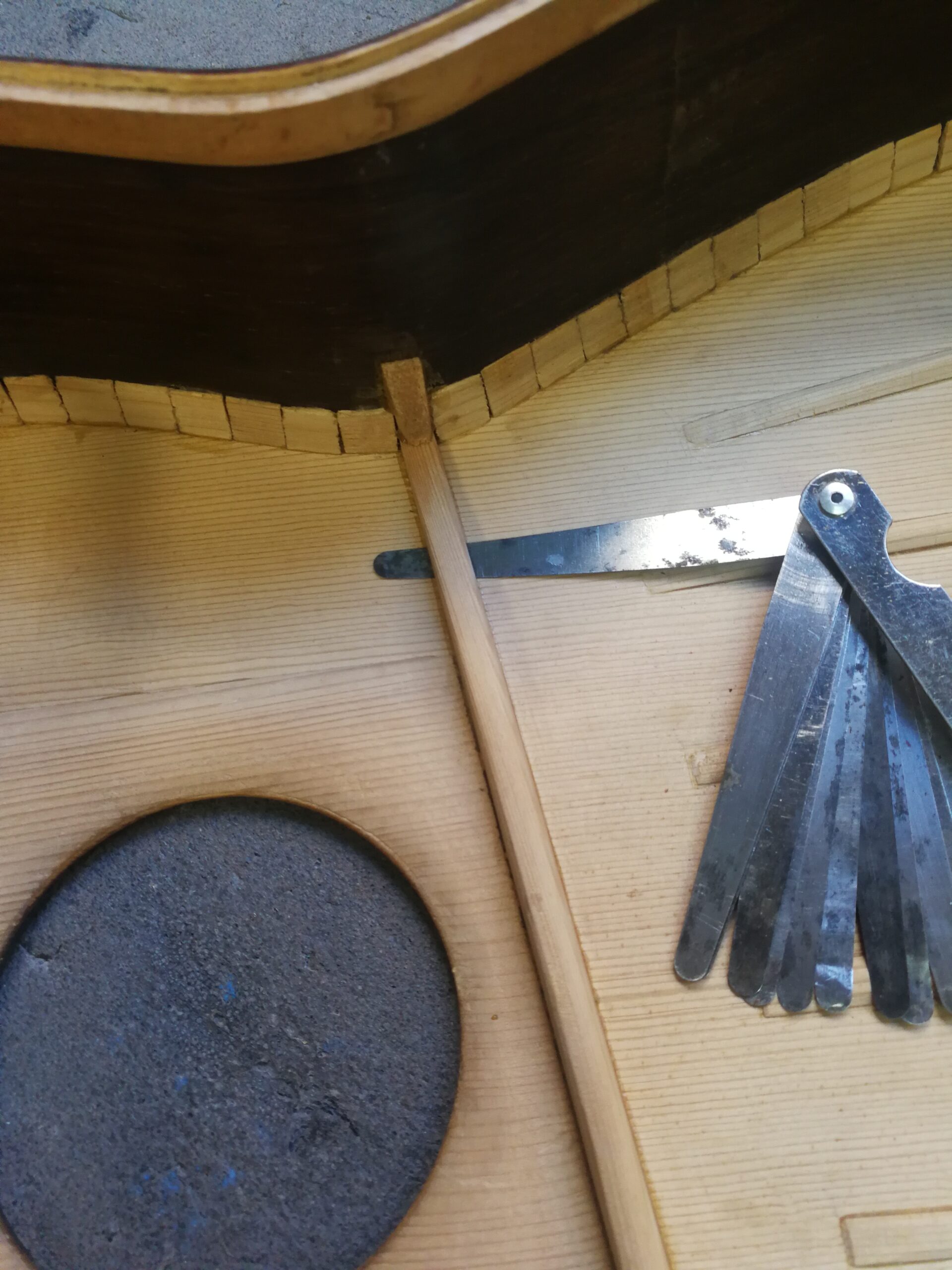 Detail of a detached brace during the restoration of the Spanish guitar